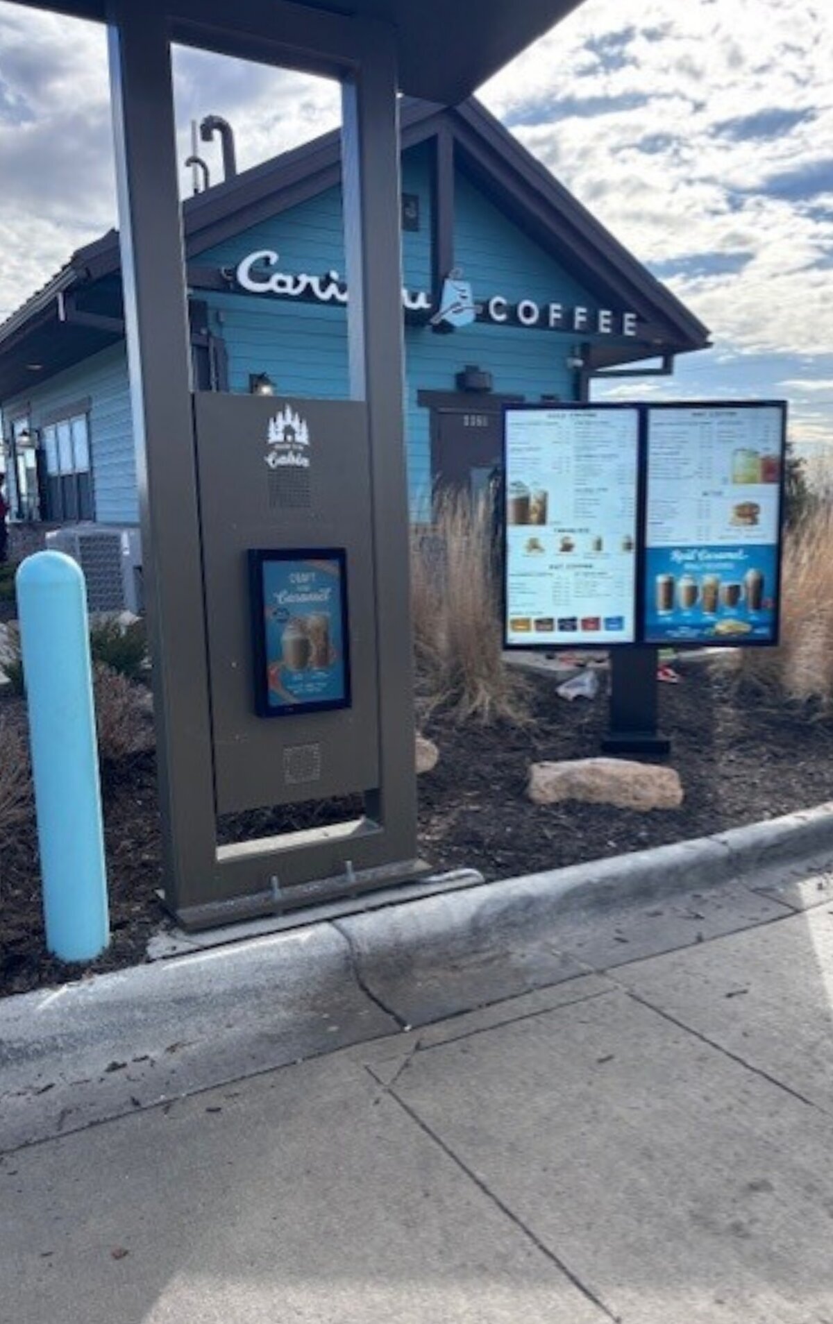 Caribou Coffee drive-thru with an outdoor digital order screen and a double-screen digital menu board