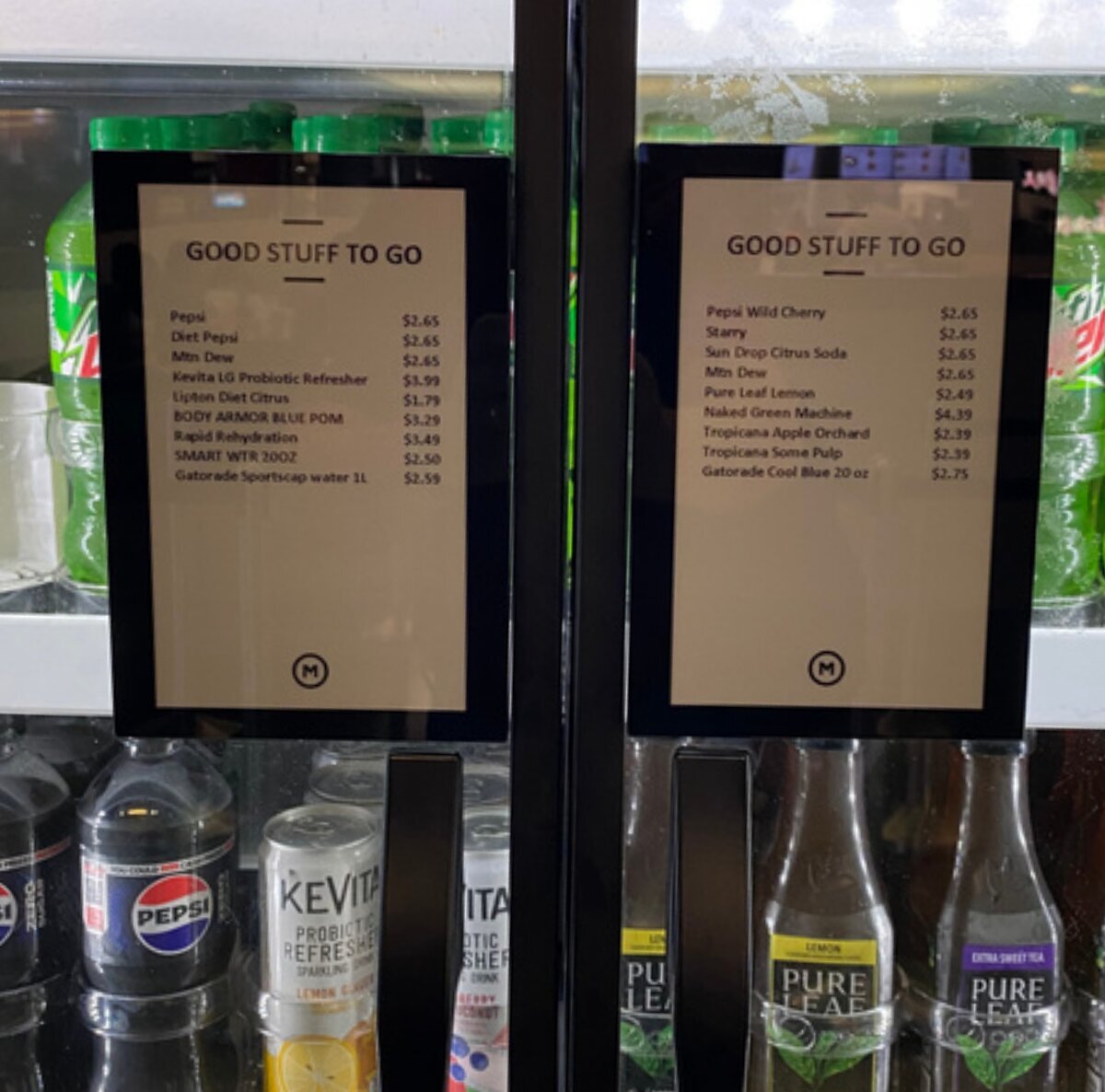 Two WAND 7-inch smart labels showing drink names and prices on beverage cooler doors