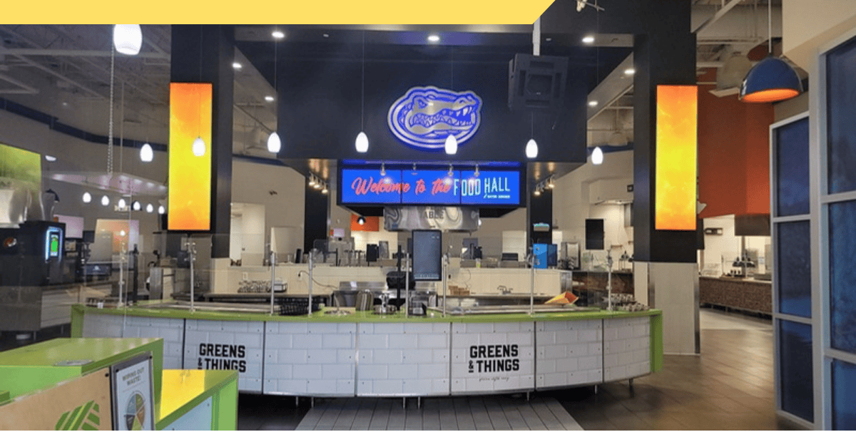 Food hall serving counter with a Welcome to the Food Hall digital sign and two vertical digital displays